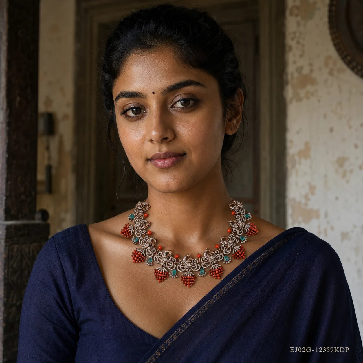 Woman in navy saree wearing a Victorian antique-finish necklace with coral bead clusters and green stone accents