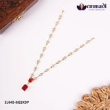 Necklace on white backdrop near a carved wooden box, heart pave links and pink stone pendant drop visible