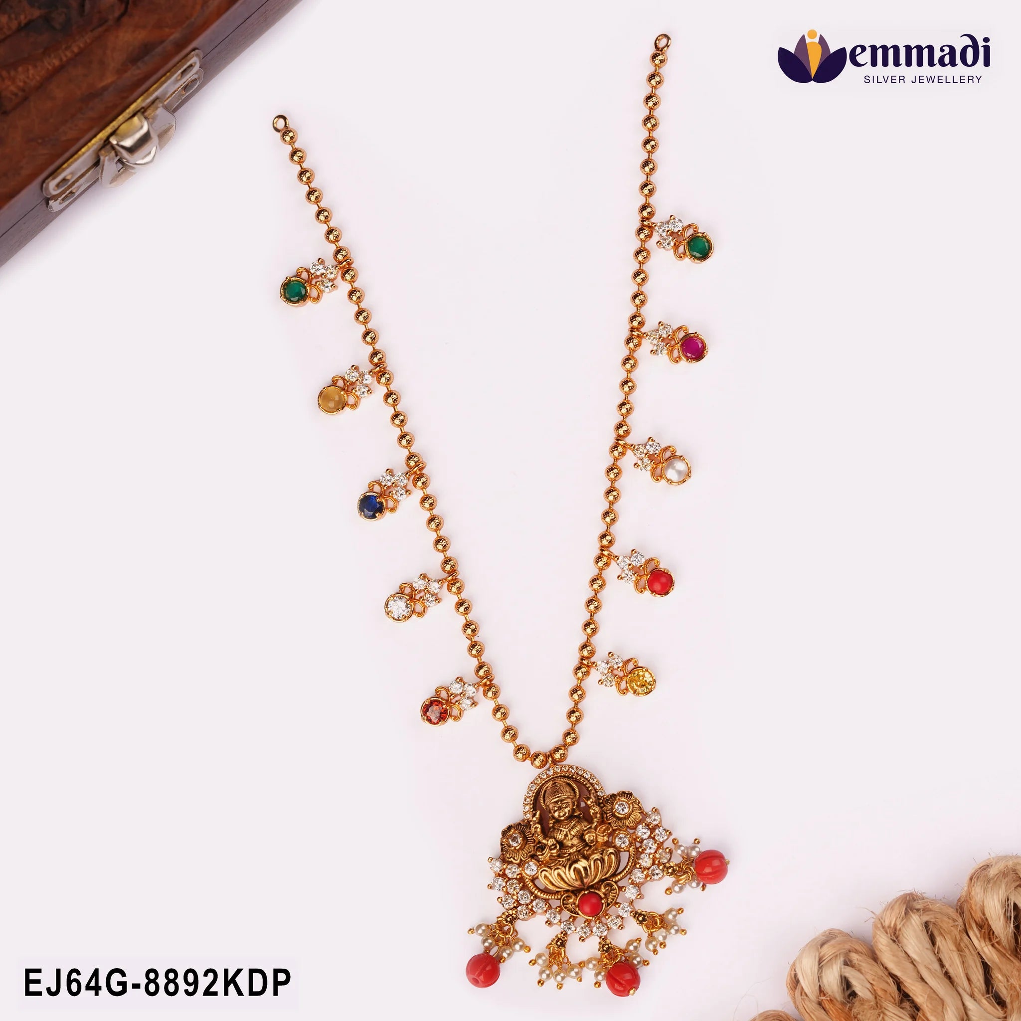 Nakshi multicolour necklace with Lakshmi pendant displayed beside a wooden box