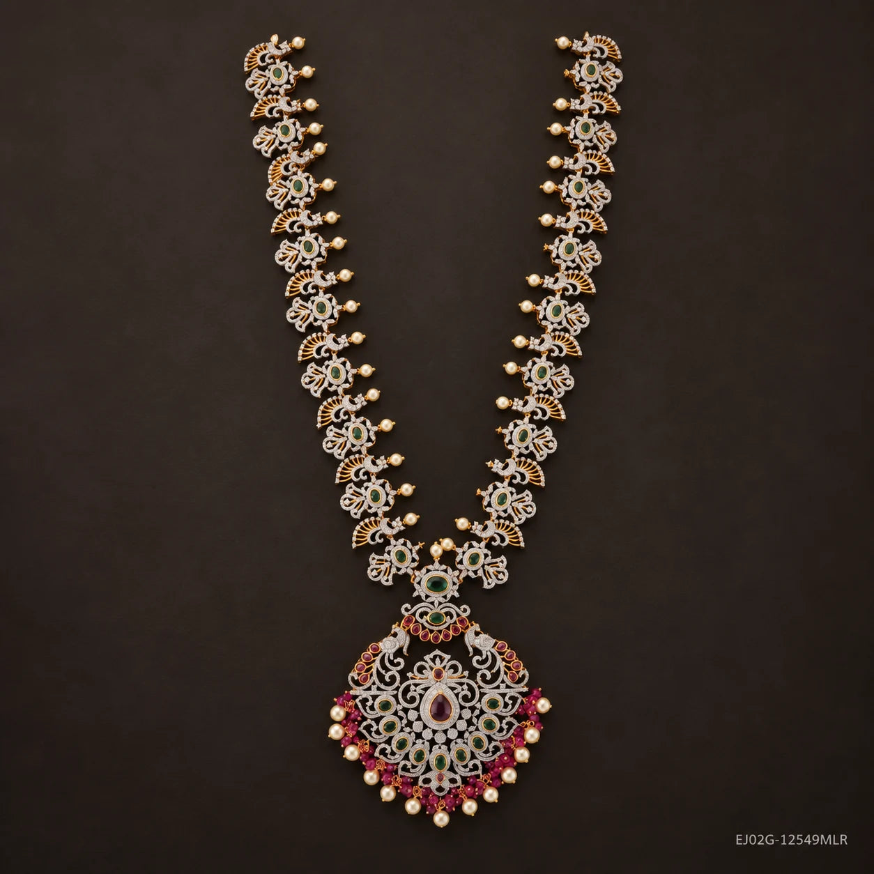 Full view of green long necklace with floral cz links and peacock pendant on dark brown background