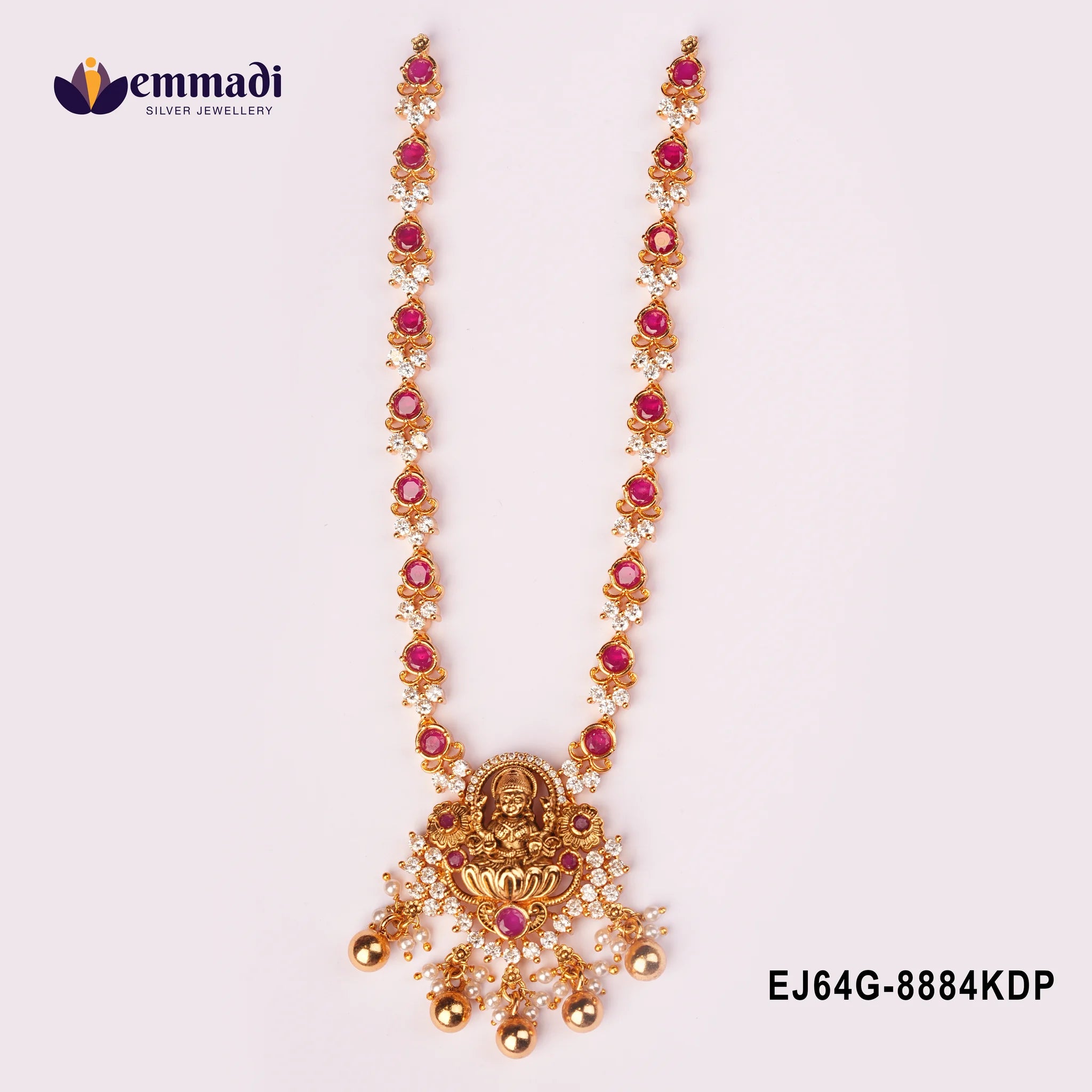 Close view of the nakshi pink necklace showing pendant detail and pearl drop tassels on plain background