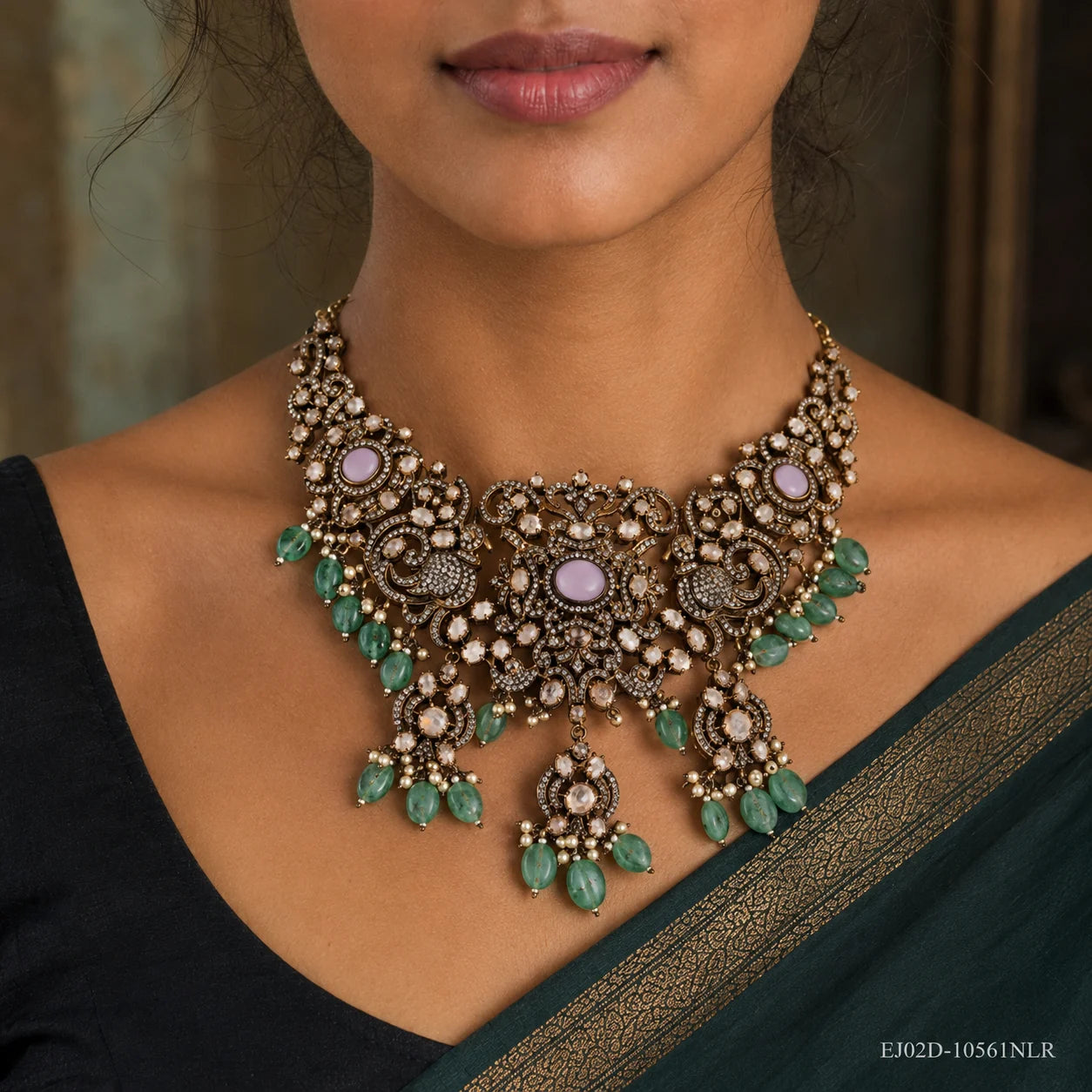 Close-up of the choker necklace on the neck showing cubic zirconia pave and green stone pearl tassels