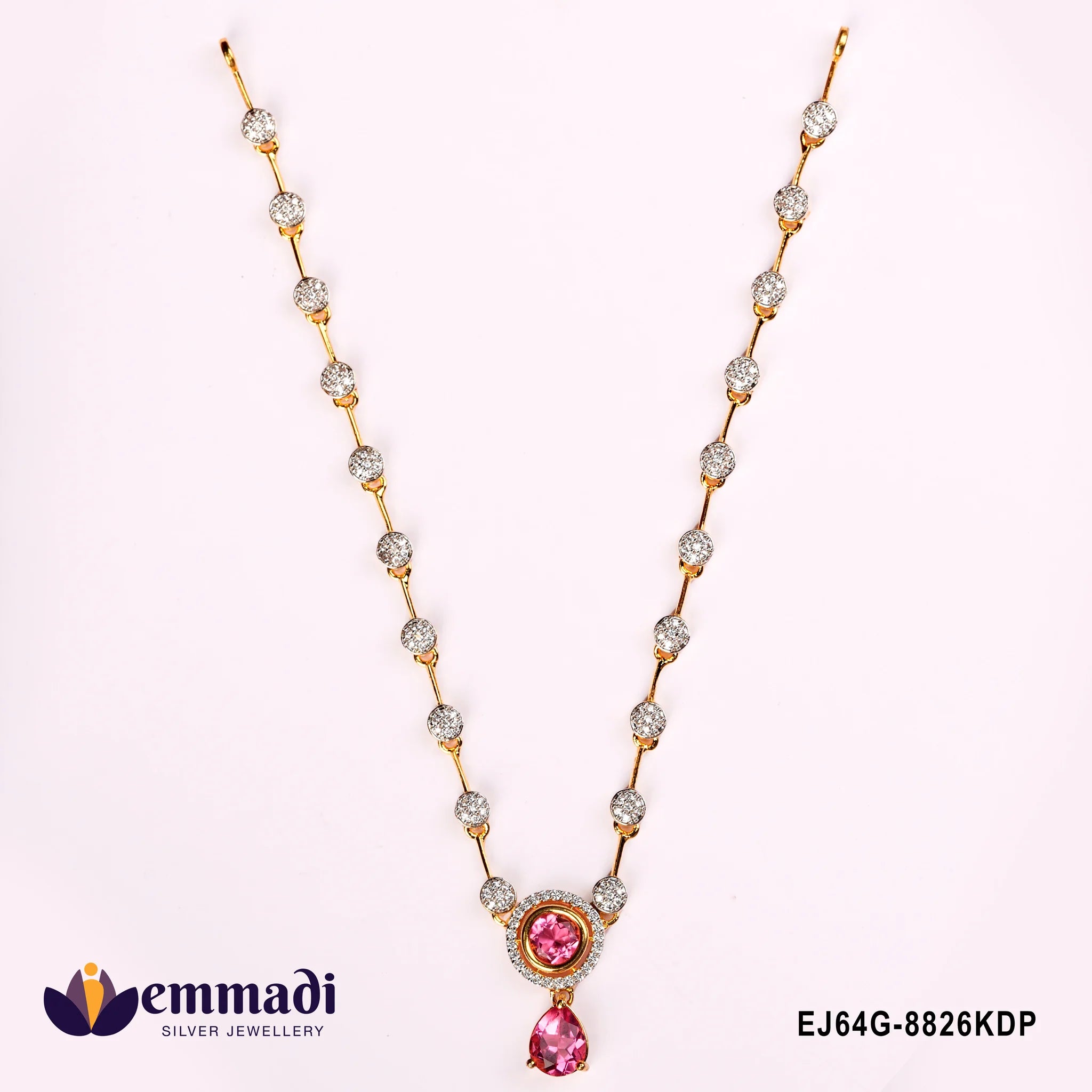 Close-up flat lay of pink CZ necklace showing pave stone stations and pear-shaped pink drop