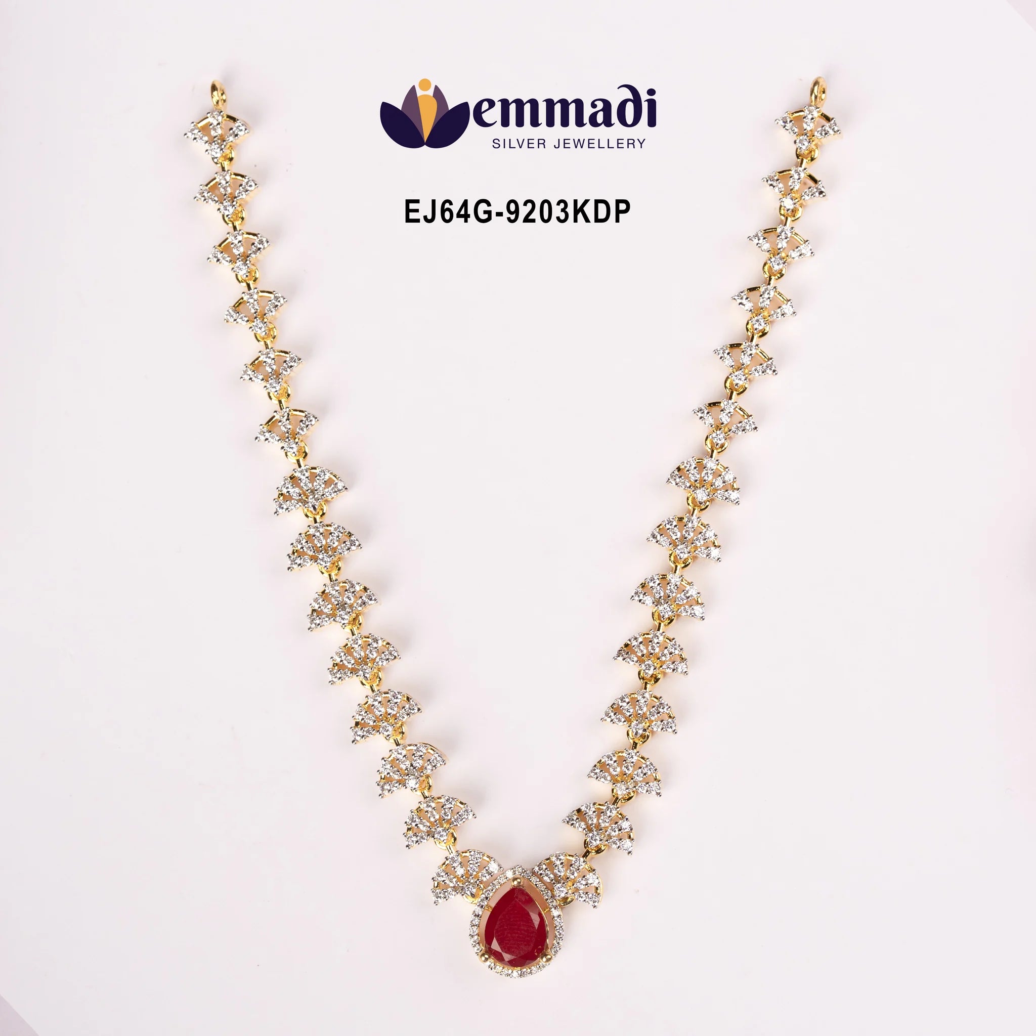 Close view of Ethika Red Necklace showing floral links and pear-shaped red pendant