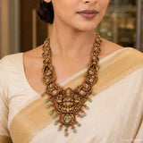 Close-up of the Kundan Nakshi necklace on the neckline, showing peacock motifs and the central deity figure