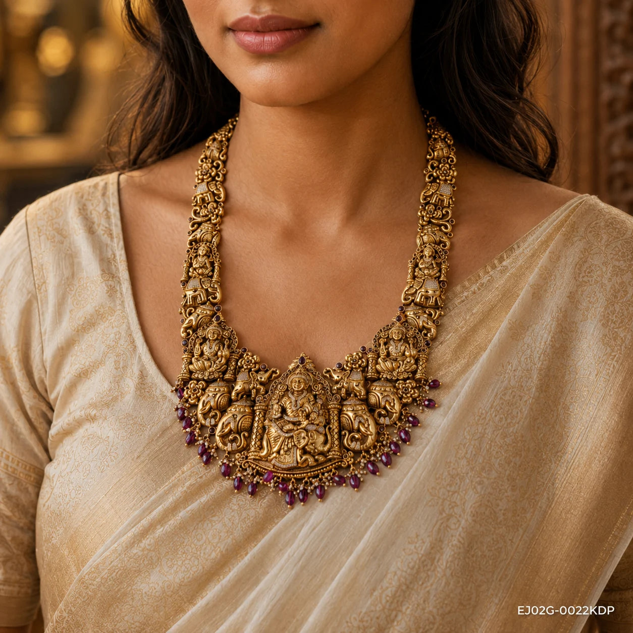 Close-up on neck and collarbone showing the nakshi necklace with deity and elephant motifs