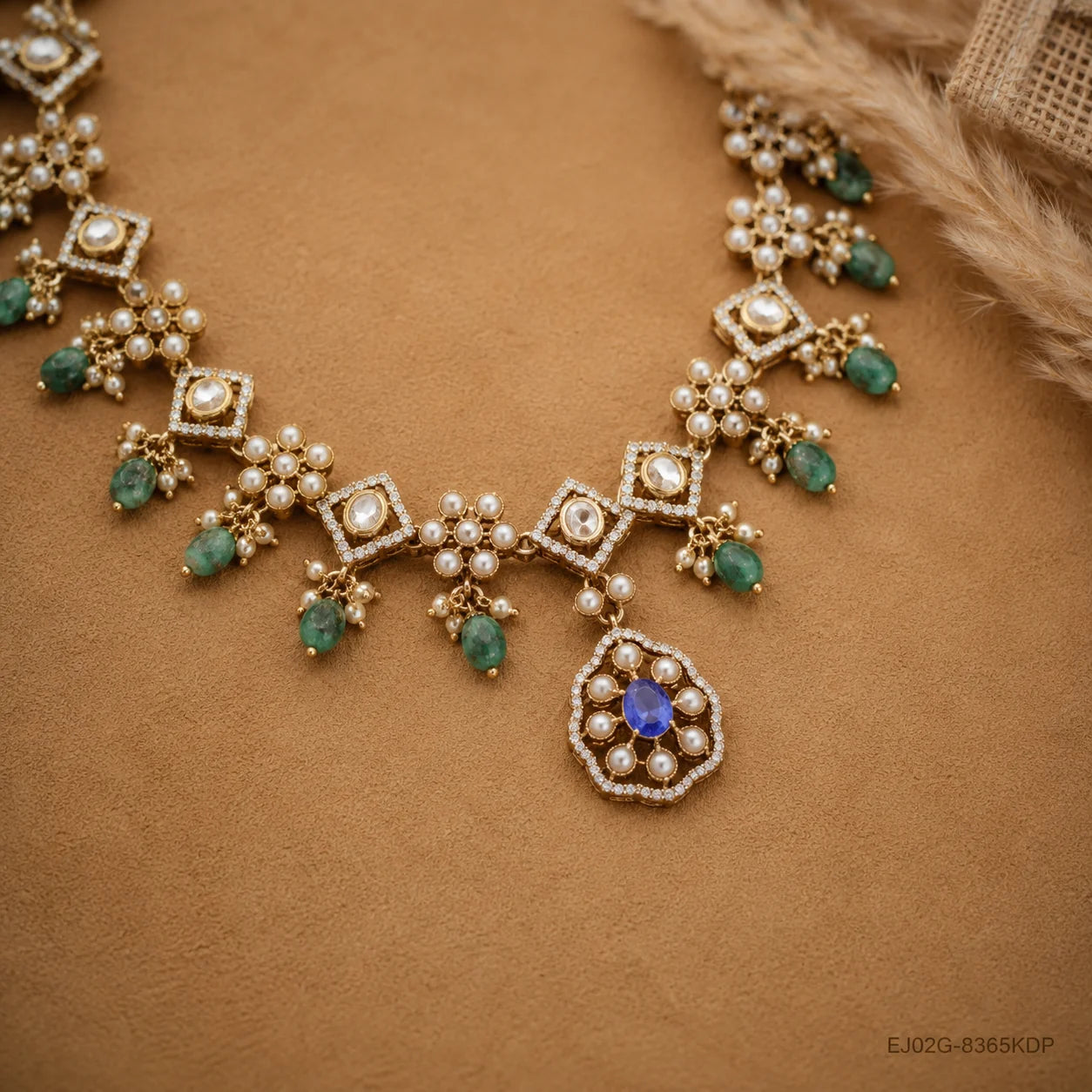 Flat lay of Victorian necklace on beige fabric showing the blue centre stone and pearl detailing