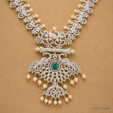 Detail of the pendant showing peacock motifs, bar design, green stone and pearl tassels