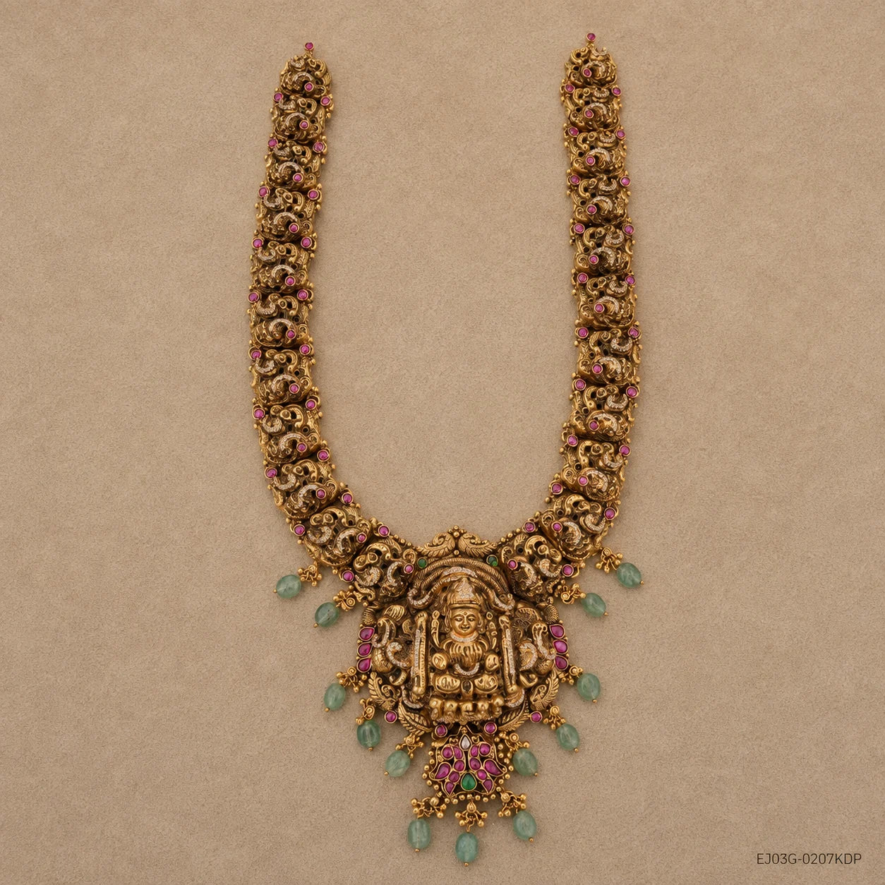 Flat lay of the full long necklace showing its U-shaped strands and detailed goddess pendant with hanging beads
