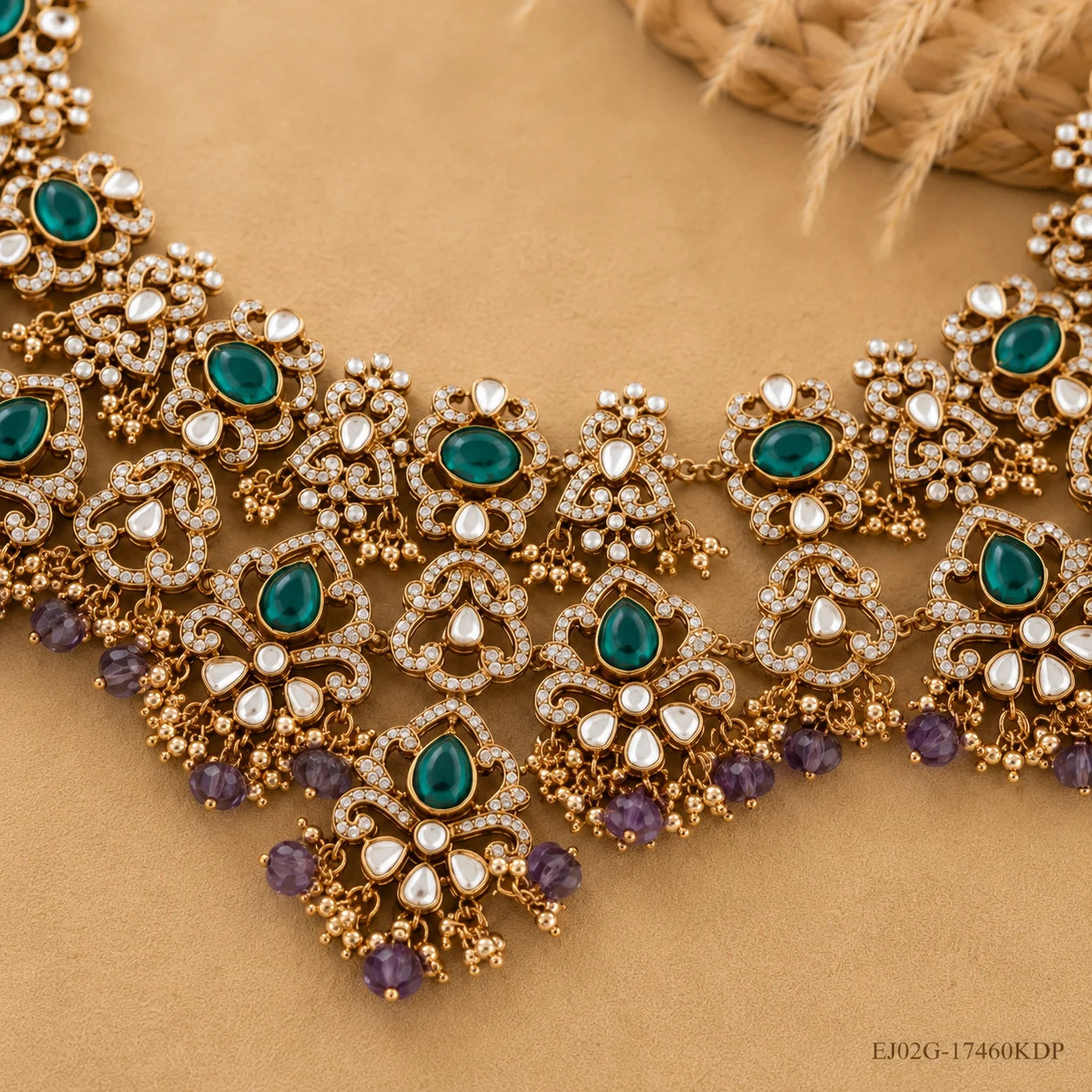 Victorian necklace laid on fabric showing antique finish, green stones and amethyst bead tassels