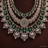 Close-up of the lower tier showing swan pendants, floral medallion centre and green stone clusters