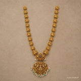 Flat lay of the full long necklace showing repeating carved floral links and the ornate pendant