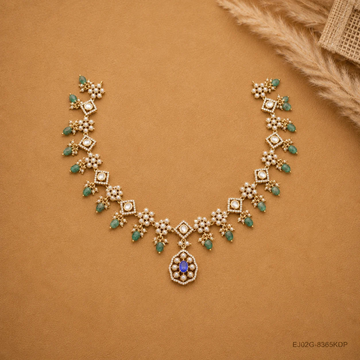 Full curved view of Victorian necklace laid on beige fabric beside a dried flower accent