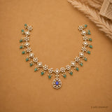 Full curved view of Victorian necklace laid on beige fabric beside a dried flower accent