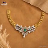 Necklace laid flat on tan fabric showing the full design with CZ pave, beaded chain and green stone accents
