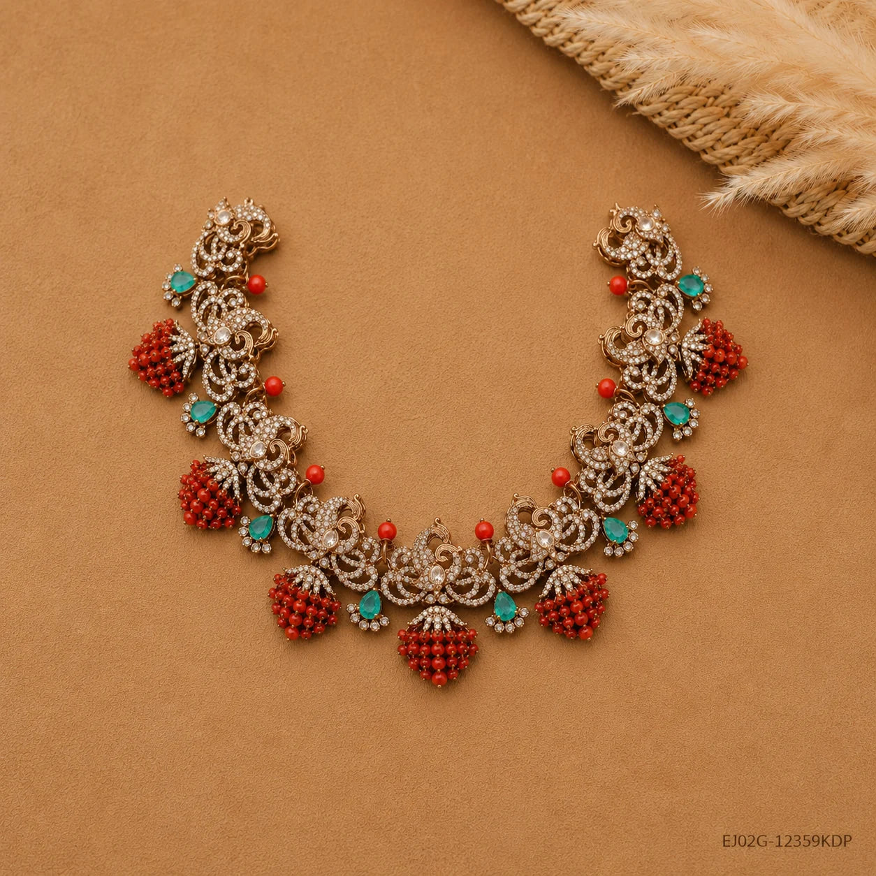Flat lay of the Victorian necklace spread open on beige fabric highlighting scrollwork and coral bead drops