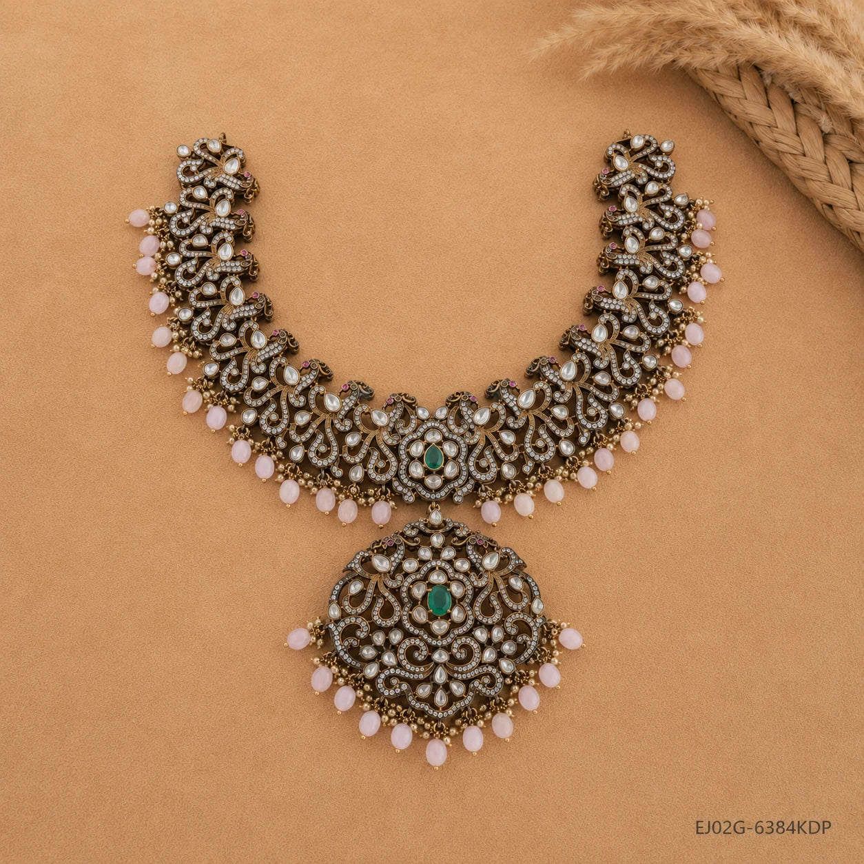 Top view of Victorian green necklace displaying full layered design with pink beads and green centre stone
