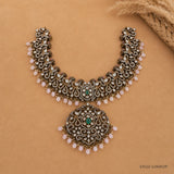 Top view of Victorian green necklace displaying full layered design with pink beads and green centre stone
