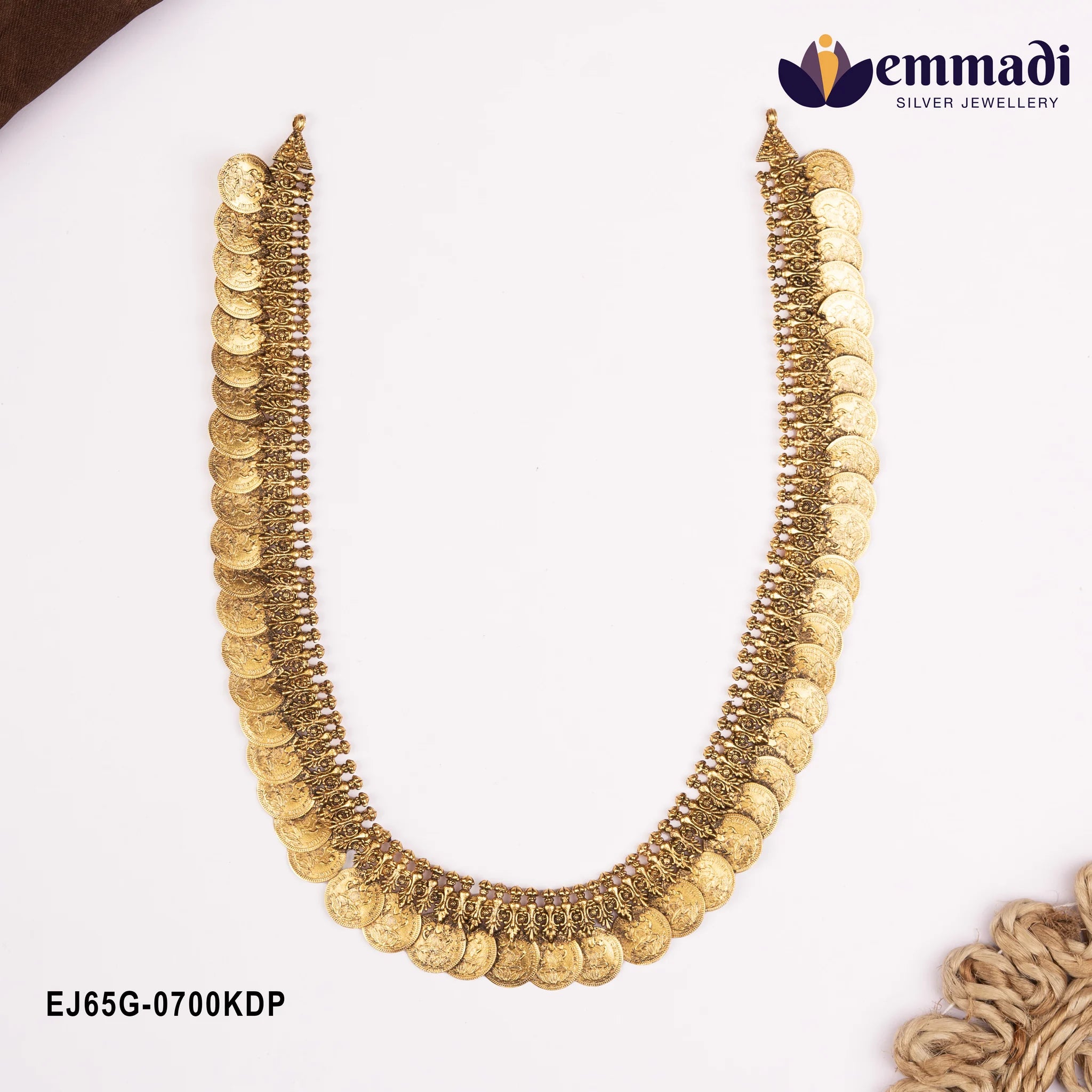 Nakshi long necklace with coin motifs laid flat in a U shape on white background