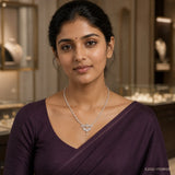 Woman in a purple saree wearing the Aadhya Ethika White Long Necklace with leaf motif pendant and pearl drop