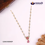 Pink CZ necklace with gold-tone chain laid flat beside a carved wooden box corner