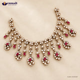 Victorian pink necklace with layered white stone clusters and pink stone drops on beige background