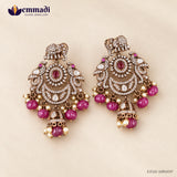 Pair of Victorian red hangings with elephant tops, peacock wings and red stone centres on beige background
