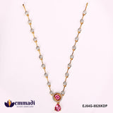Close-up flat lay of pink CZ necklace showing pave stone stations and pear-shaped pink drop