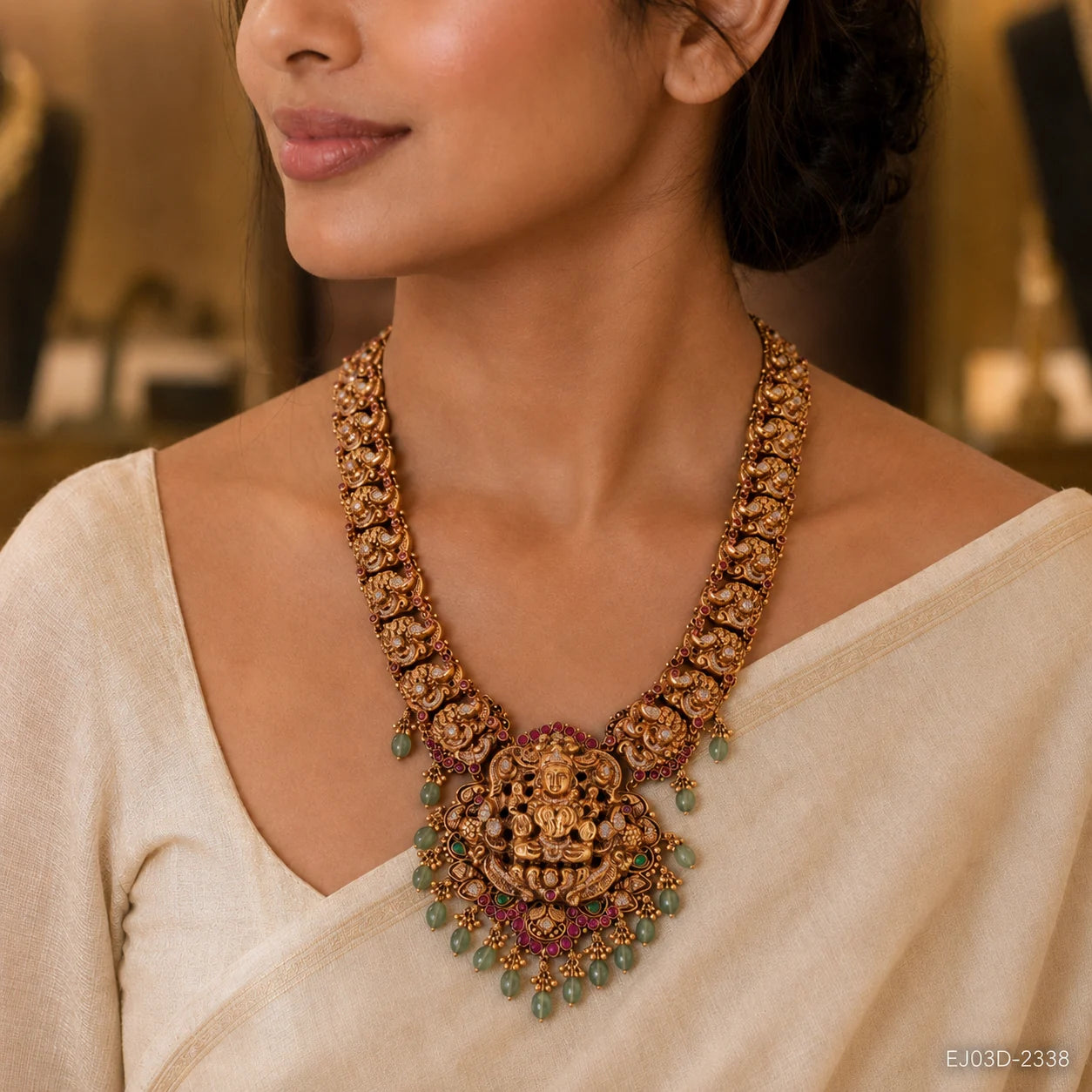 Close-up of the necklace on the neckline showing the carved pendant and green bead drops
