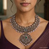Close-up of Victorian green necklace showing floral pendant with green stone and pink bead fringe