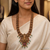 Close-up of the necklace on the model showing layered Nakshi strands, pink stones and green teardrop beads