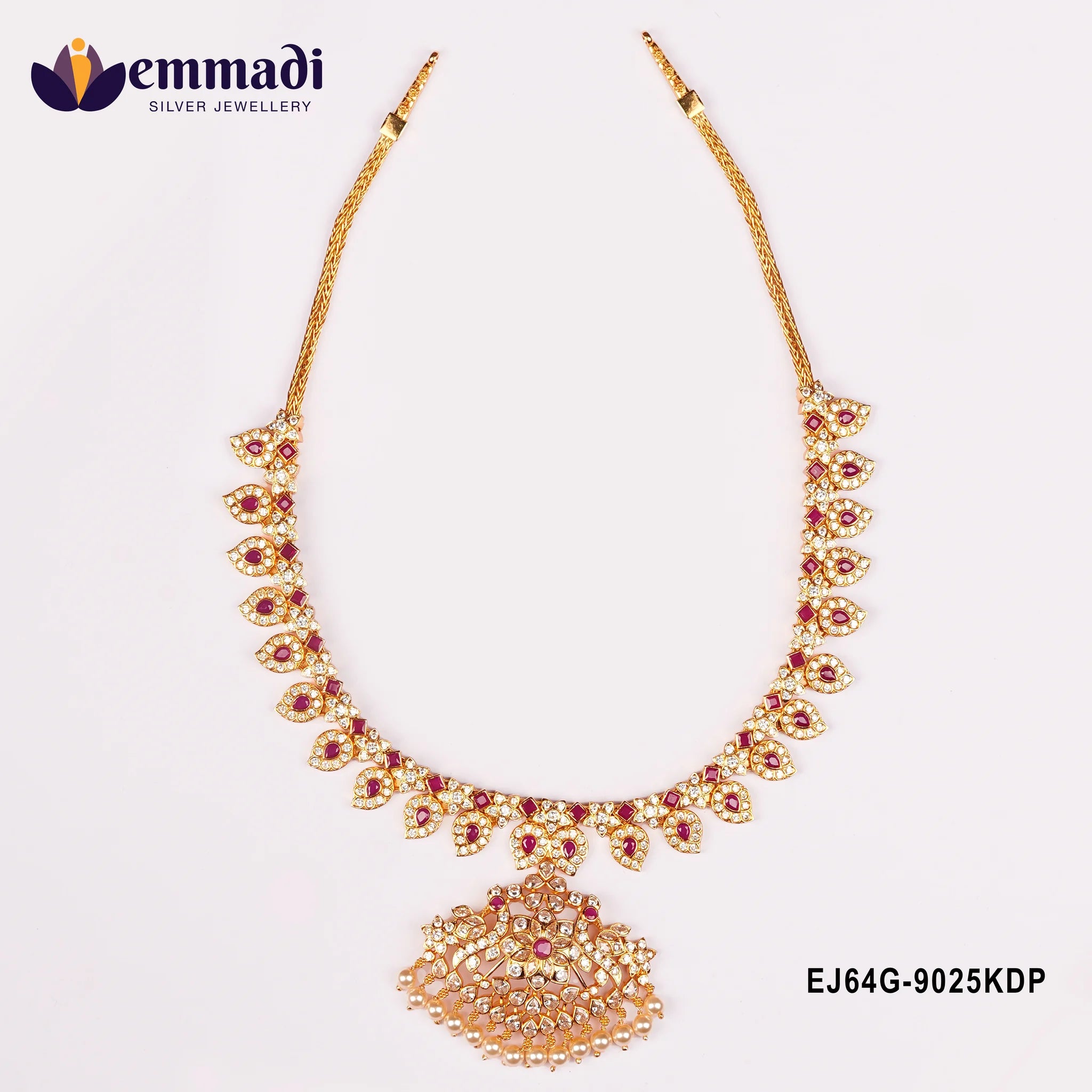 Close view of the long necklace with pink stone leaf links and a large pearl fringed pendant