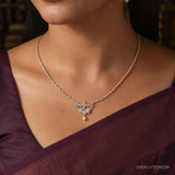 Close-up of the Ethika White Long Necklace worn at the collarbone, showing pave clusters and pearl drop