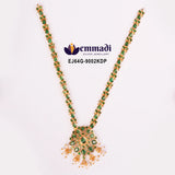Green stone necklace with floral pendant and pearl tassels laid flat on white background