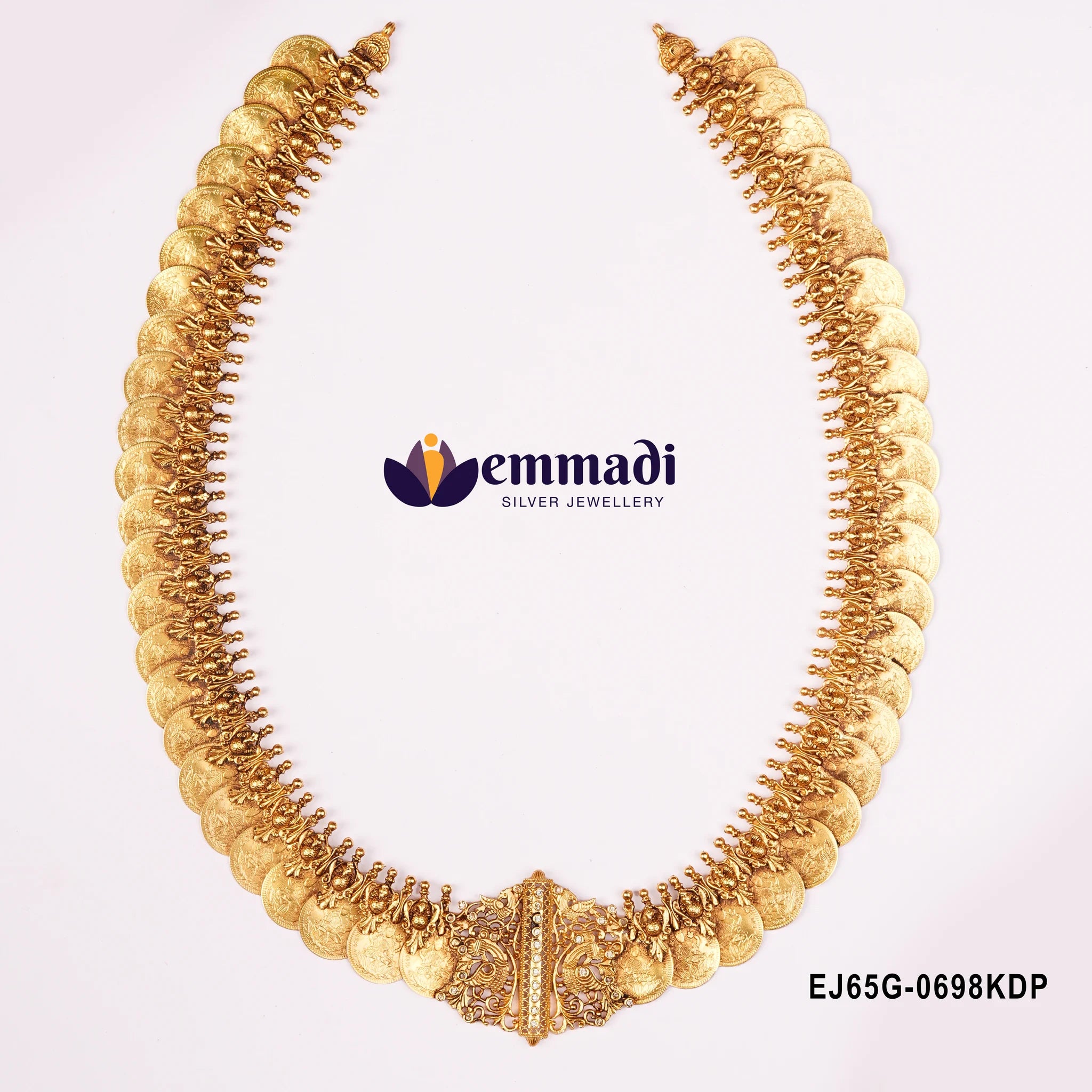 Close view of nakshi long necklace showing coin rows and peacock pendant centre on white background