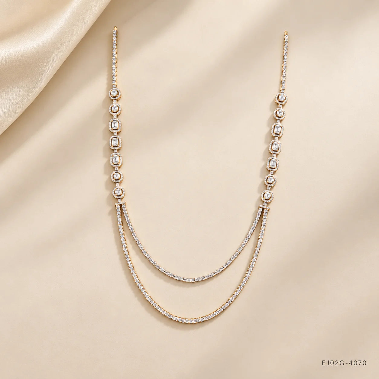 Full view of Ira Ethika white long necklace laid on cream fabric with gold-tone pave setting