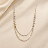 Full view of Ira Ethika white long necklace laid on cream fabric with gold-tone pave setting