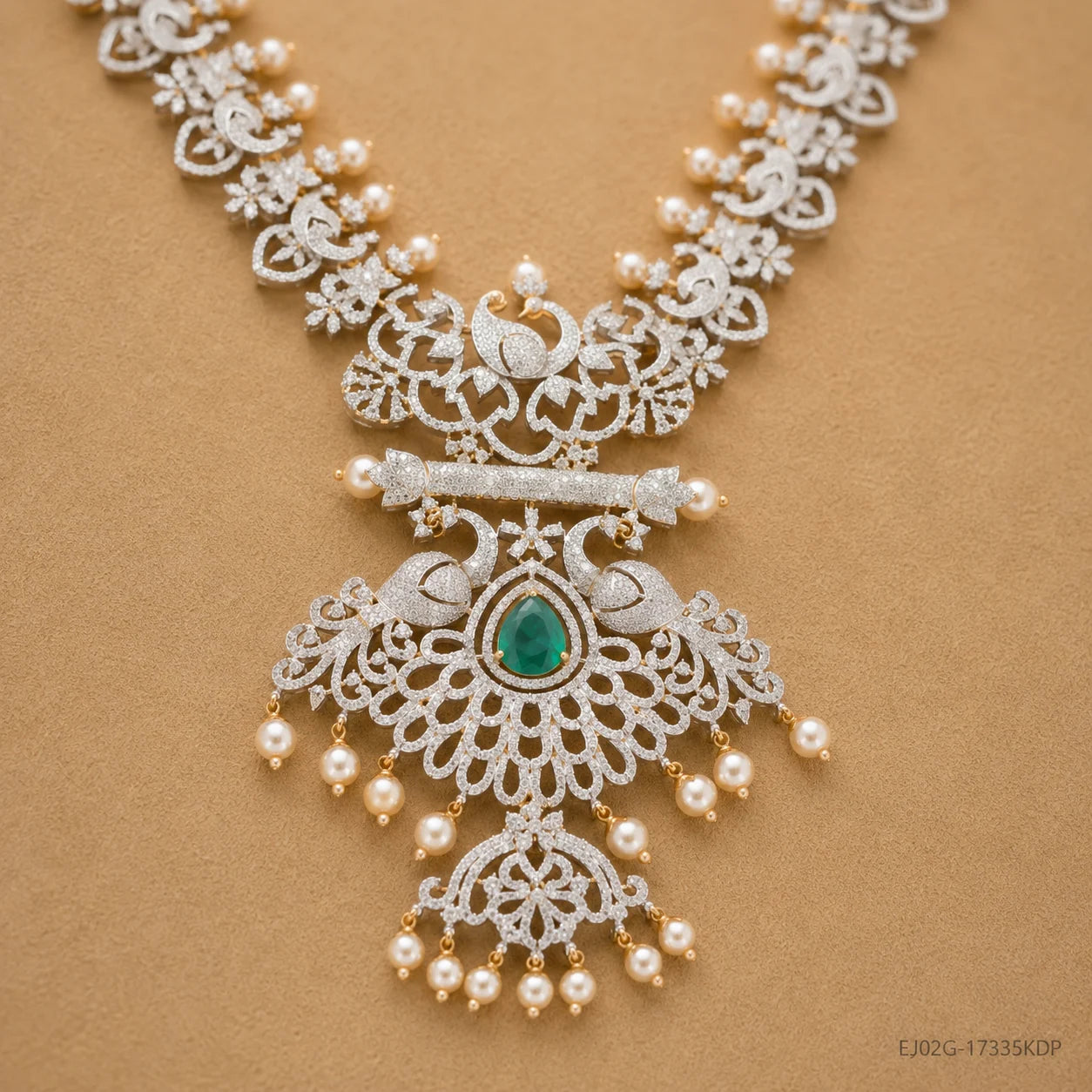 Detail of the pendant showing peacock motifs, bar design, green stone and pearl tassels