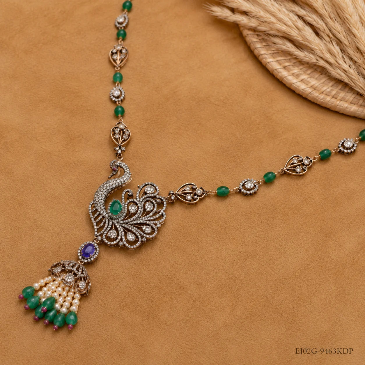 Flat lay of Victorian long necklace showing peacock pendant, green beads and tassel drop