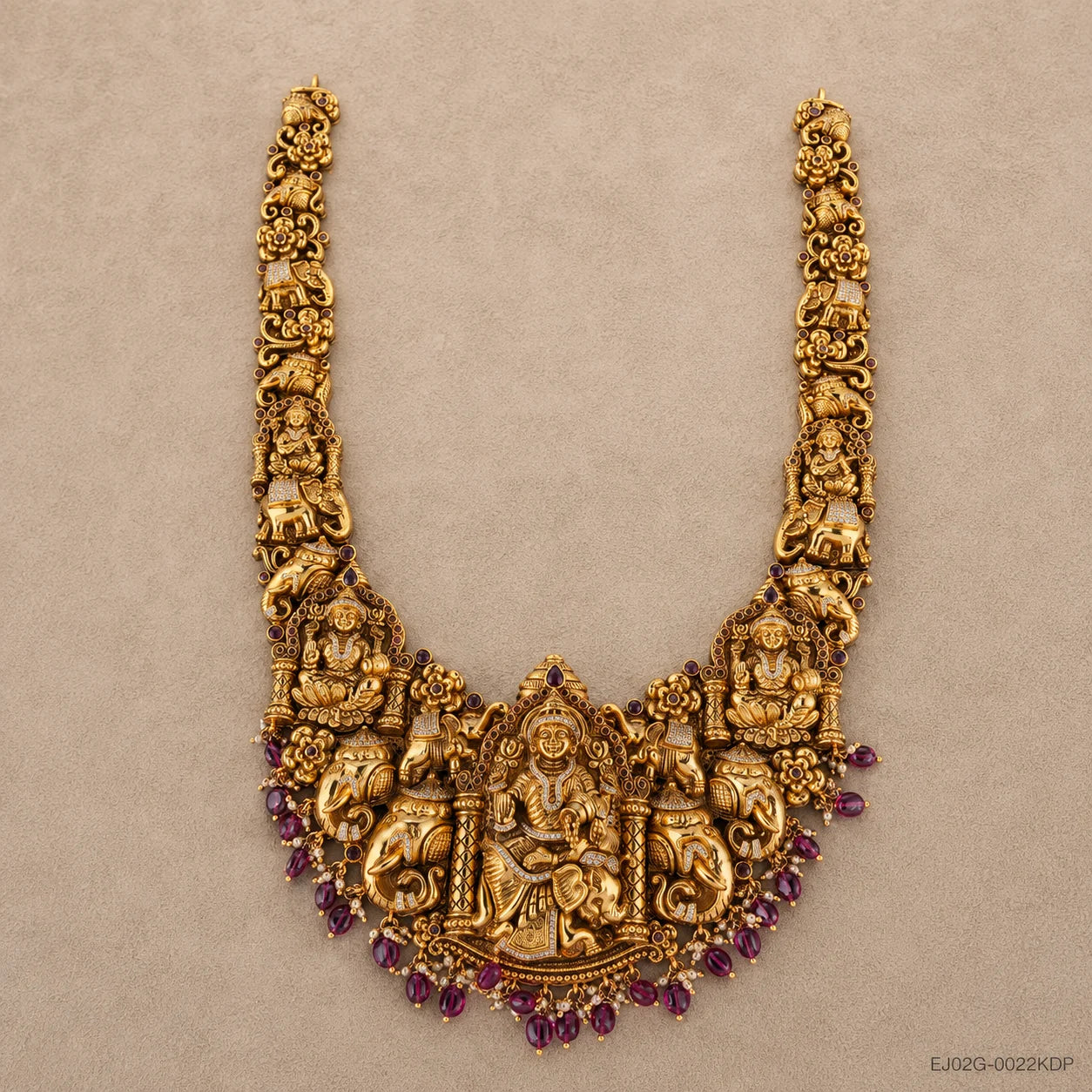 Full flat-lay view of the long necklace with pendant, chain medallions and pink bead fringe