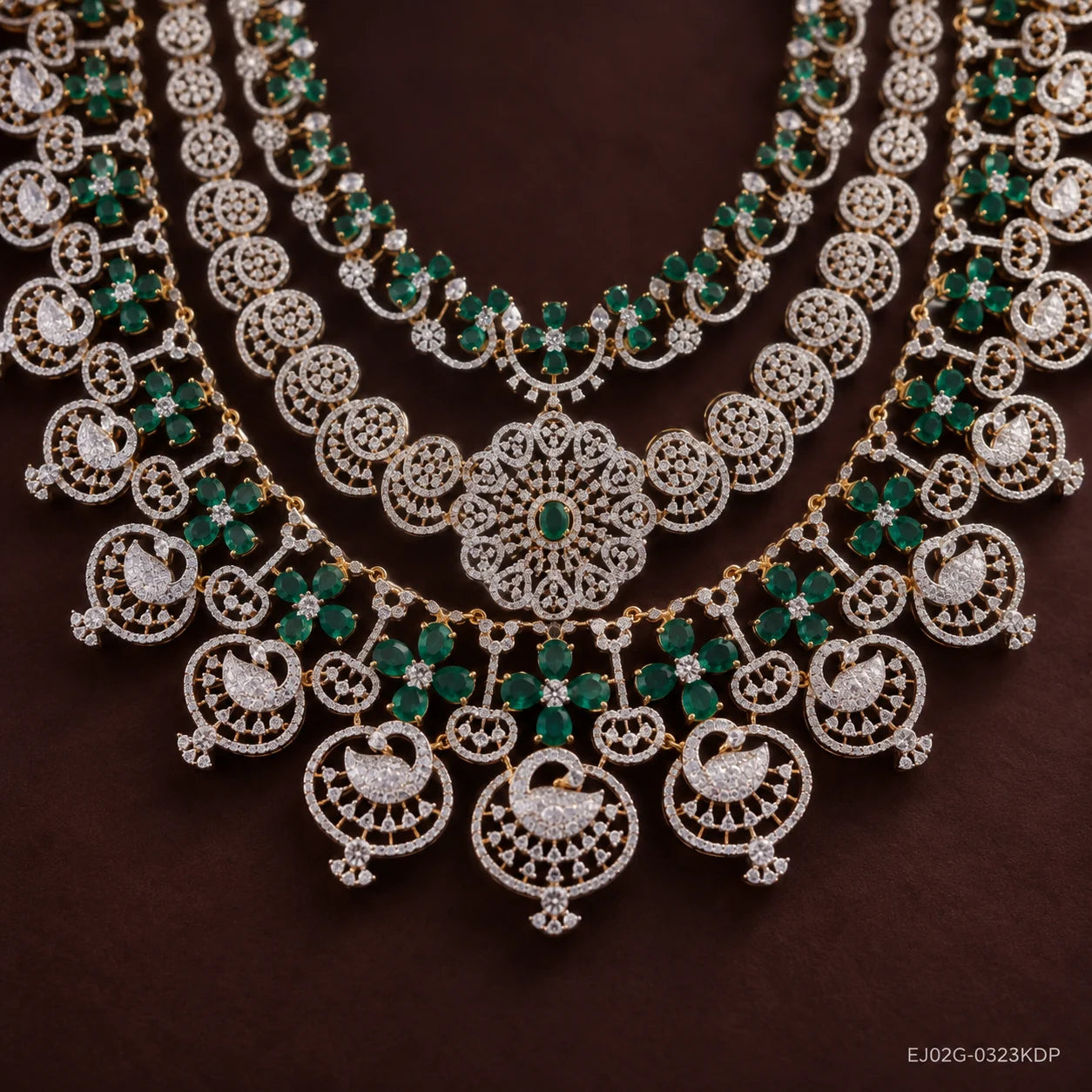 Close-up of the lower tier showing swan pendants, floral medallion centre and green stone clusters
