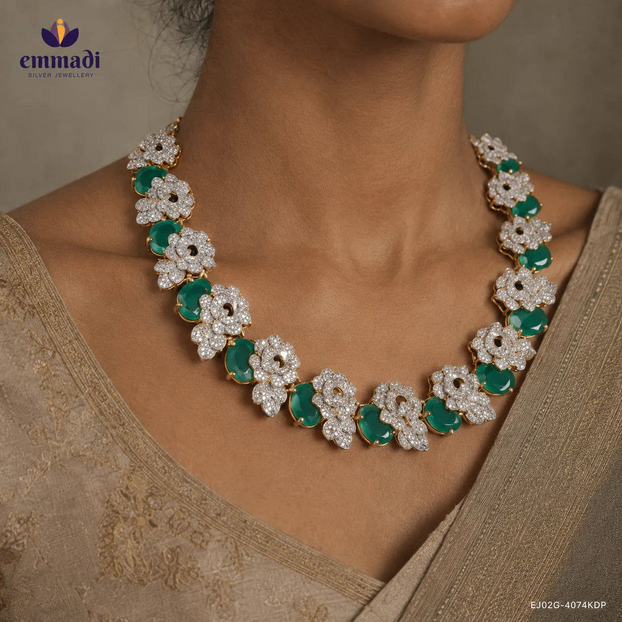Close up of the necklace on a woman's neckline showing floral white stone clusters alternating with oval green stones
