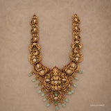 Full flat-lay view of the Kundan Nakshi long necklace showing its U-shaped design and green bead drops