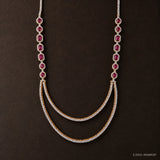 Close-up of the pink gemstone and pave stone details with the draped double-row design, dark backdrop