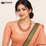 Woman in an orange saree wearing the multicolour stone necklace with teardrop pendant ends