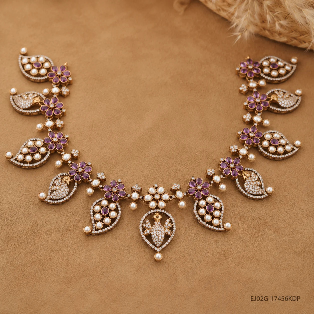 Victorian pink necklace laid flat on beige fabric showing full floral and peacock design