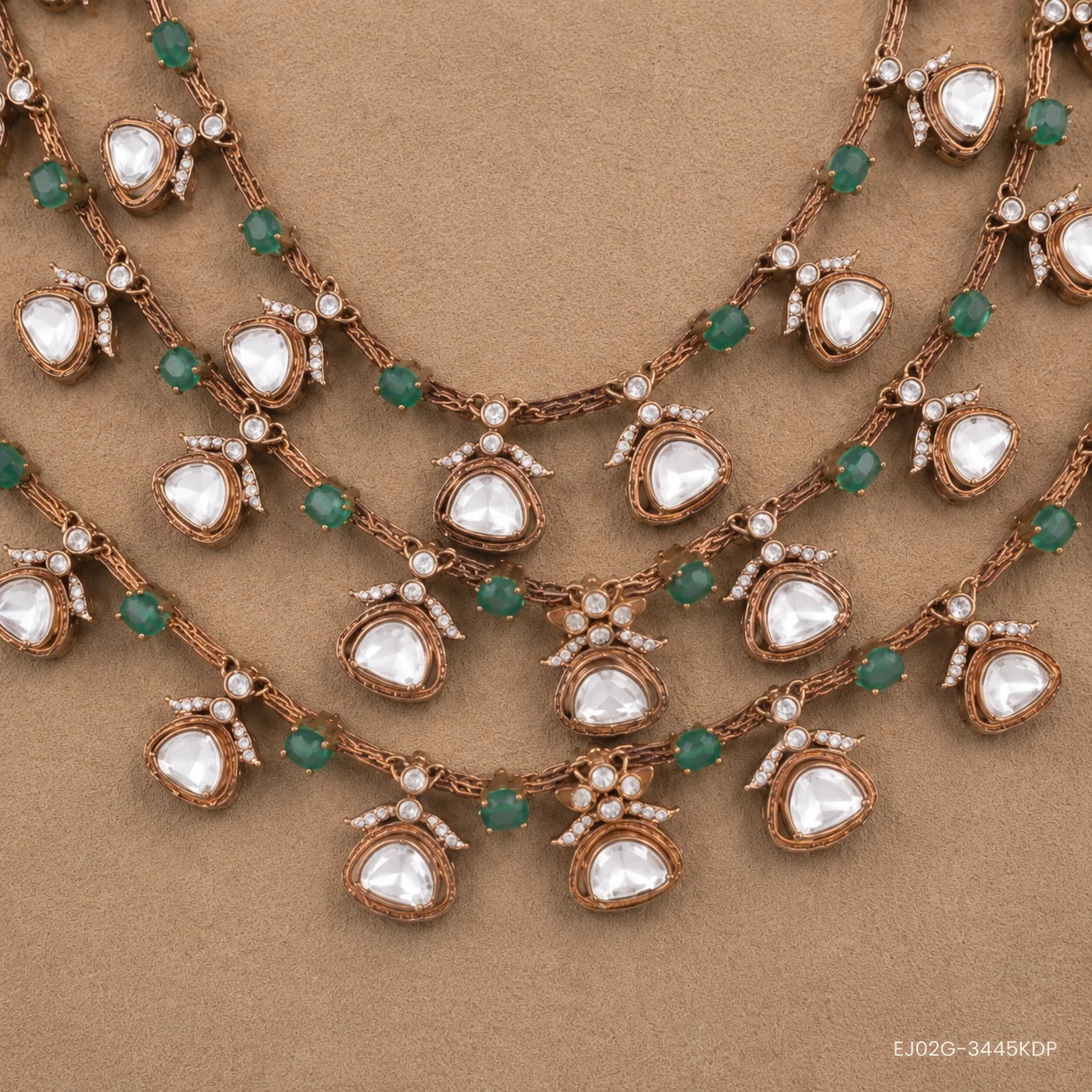 Close-up of the necklace's central pendant cluster showing white stones, green beads and floral motifs
