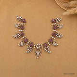 Overhead view of the Victorian pink necklace arranged on a beige backdrop with straw decor