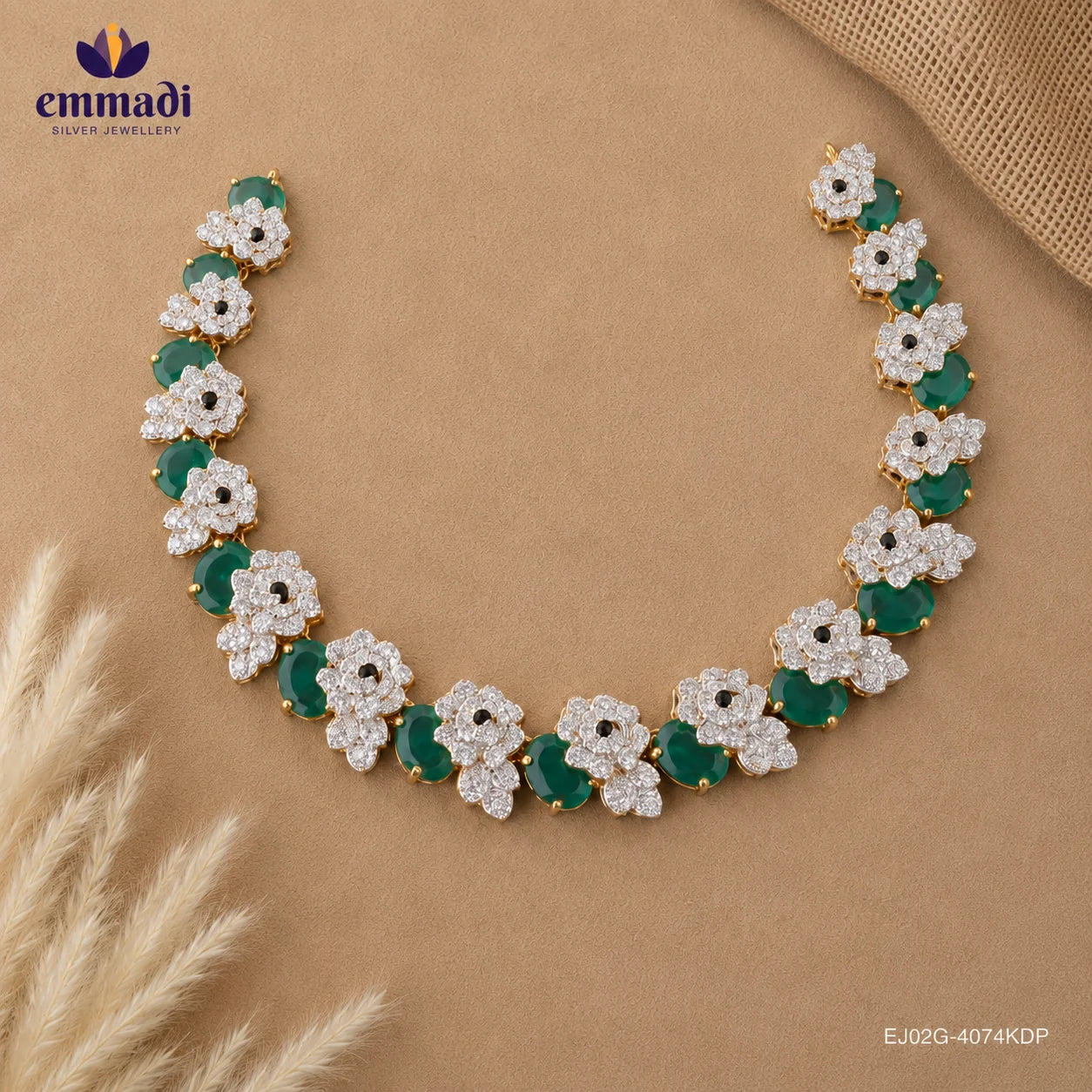 Flat lay of the green and white floral cubic zirconia necklace displayed open on beige fabric