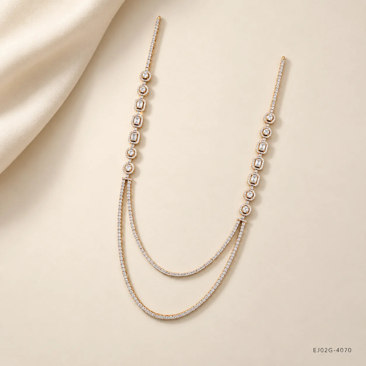 Ira Ethika white long necklace styled flat on cream fabric with draped silk corner